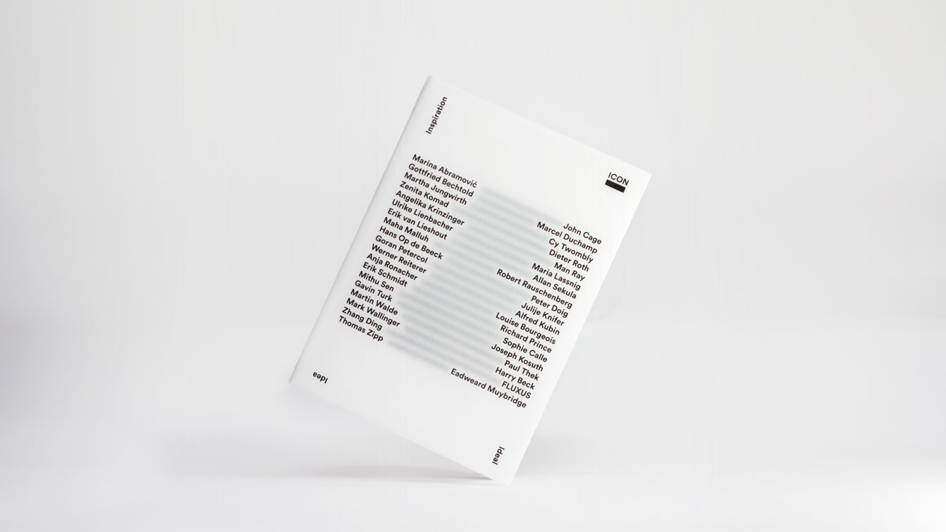 Front view of the exhibition brochure with white cover, black font, against a white background