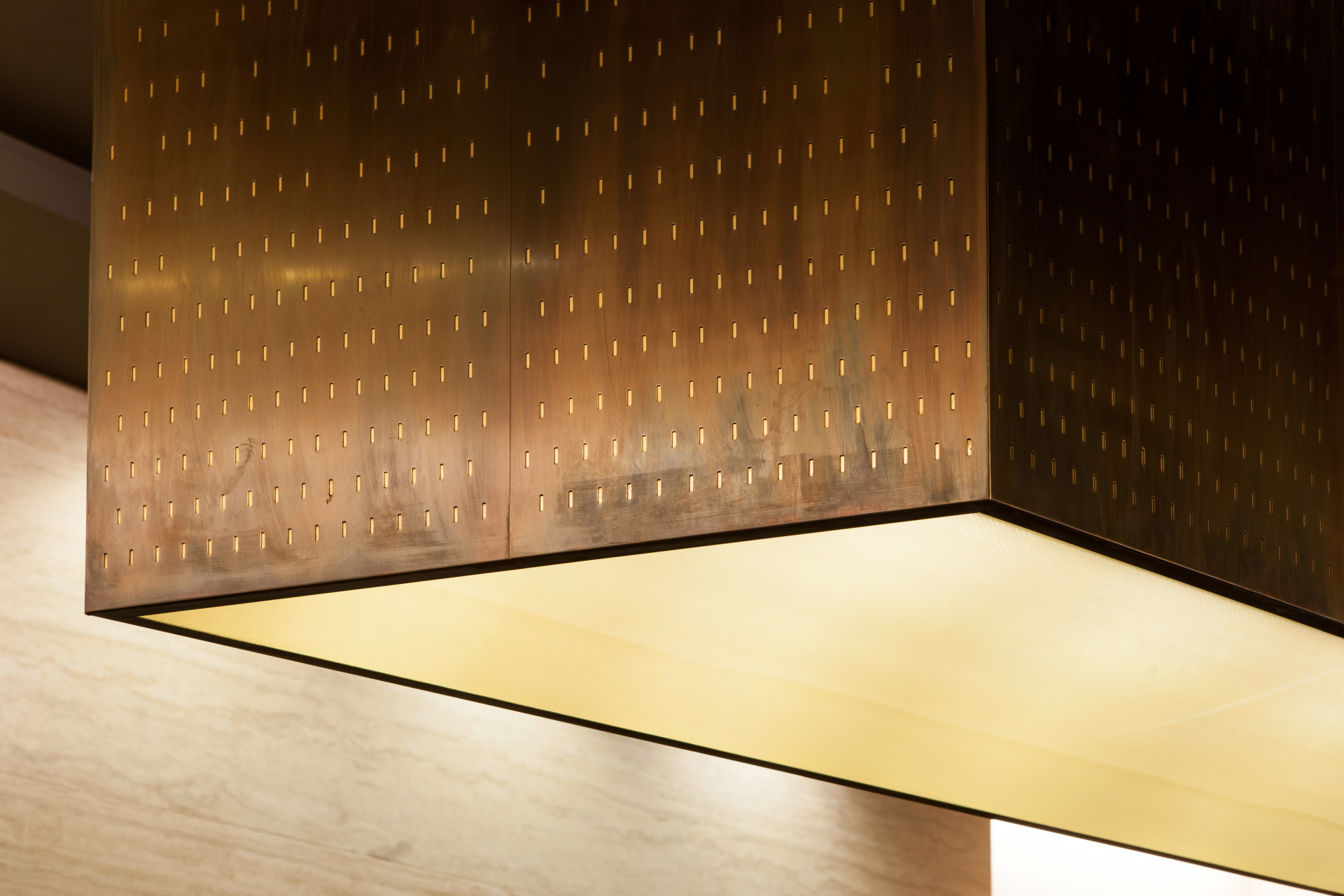 Detail of the golden cube that hangs as a light installation in the entrance area