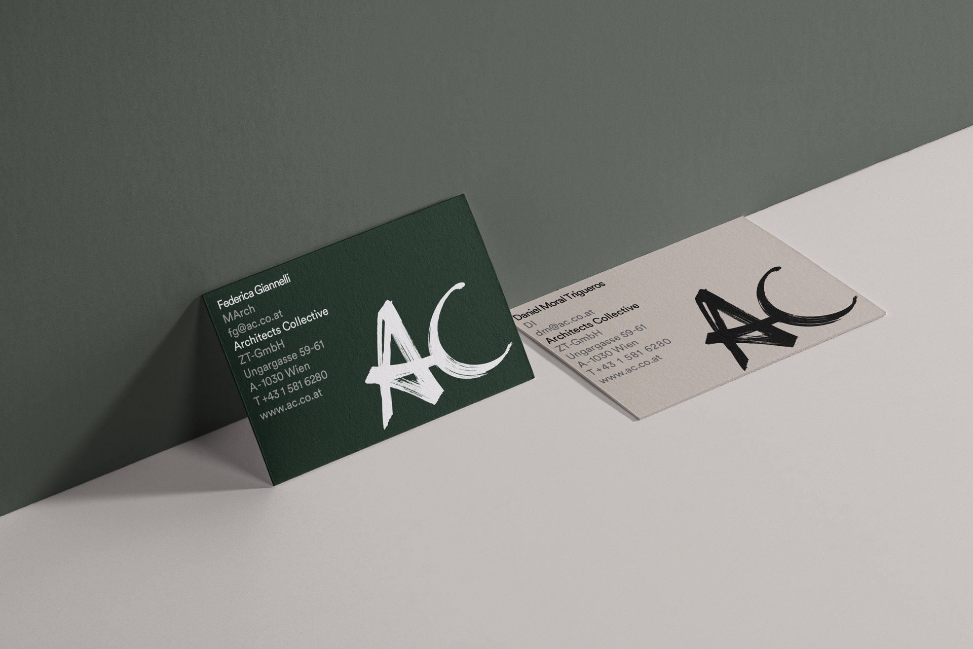 Petrol gray business cards with handwritten logo and address, front and back are in different colors